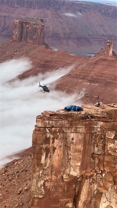 Helicopter over canyon cliff, Moab UT