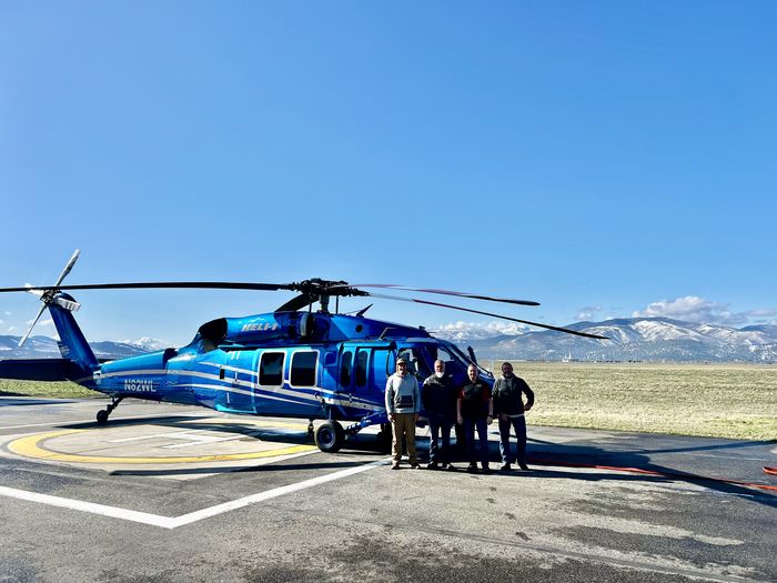 Blue UH-60 on mountain ramp with team