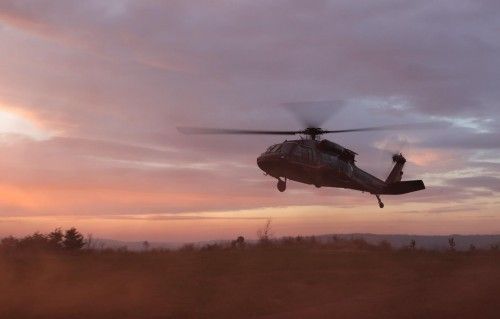 UH-60 Black Hawk at sunset — low-level flight
