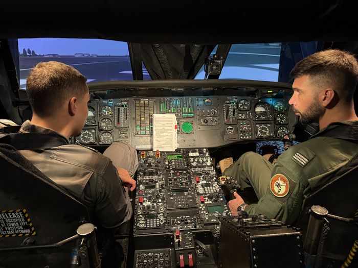 Two Portugal Air Force pilots in UH-60 simulator cockpit