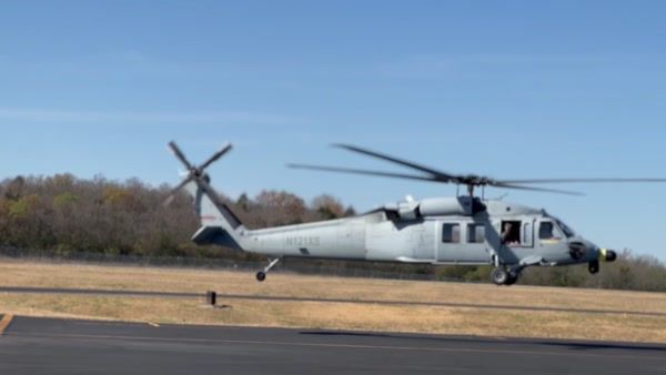 UH-60 N121KS hovering at John C. Tune Airport