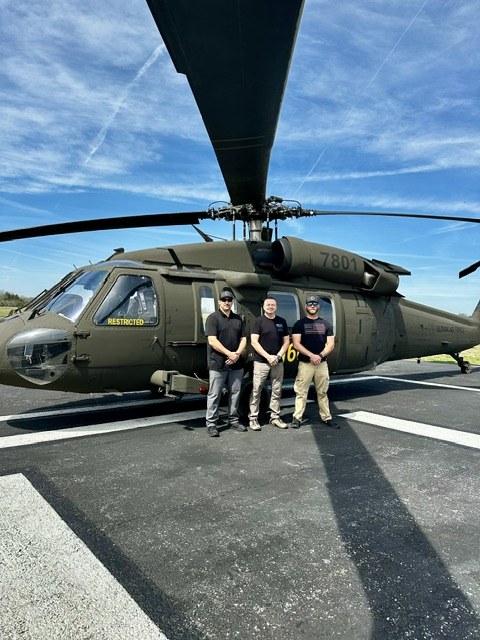 The 30 Seconds Out team in front of a UH-60 Black Hawk